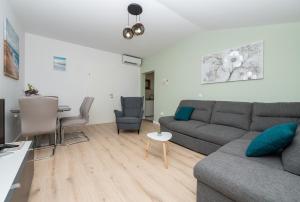 a living room with a couch and a table at Apartman Marin in Makarska