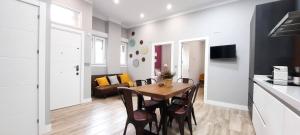 a kitchen and dining room with a table and chairs at Cruces Hospital Metro in Barakaldo +10 photos