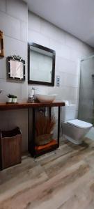 a bathroom with a sink and a toilet and a mirror at Cruces Hospital Metro in Barakaldo