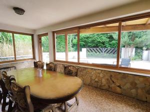 a dining room with a table and some windows at Chatka Gatterhof in Hodruša +20 photos