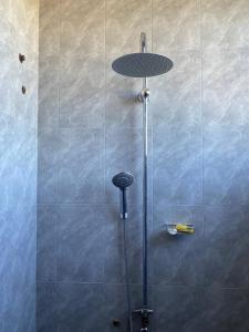 a shower with a glass separator in a bathroom at Elly's Classic Villa in Dar es Salaam
