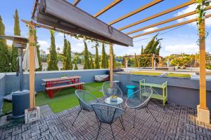 a patio with chairs and a table and a pergola at Chic, Modern Silver Lake Oasis with Rooftop Panoramic DTLA Views & Private Garage in Los Angeles