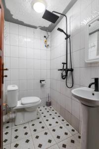 a bathroom with a toilet and a sink at Haber Motel Enterprise Ltd in Entebbe