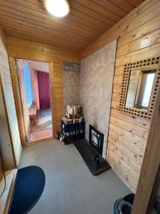 a room with a fireplace in a wooden cabin at Maja saunaga in Rõmeda