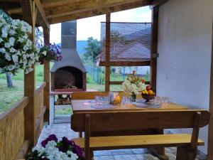 a table with glasses and a fireplace in a house at Kuća za odmor Miriam in Otočac