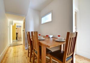 a dining room with a wooden table and chairs at Conkers in Swanage