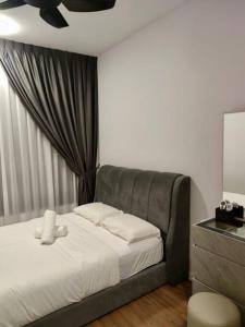 a bedroom with a bed with a gray headboard at M Vertica kl 3r2b 7 pax cosy house 3min mrt, sunway velocity mall, 8min ikea in Kuala Lumpur