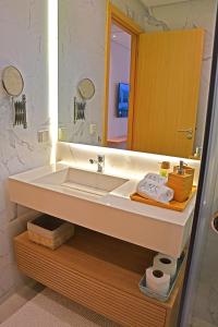 a bathroom with a white sink and a mirror at AKS Home appart 1 - CABONEGRO in Cabo Negro
