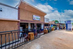 a restaurant with chairs on the outside of a building at Haber Motel Enterprise Ltd in Entebbe