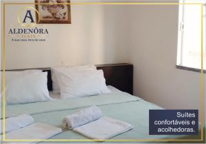 a bedroom with a bed with two towels on it at Aldenora Flats in Fortaleza