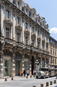 a building with a car parked in front of it at The Originals Boutique, H&ocirc;tel Danieli, Avignon in Avignon