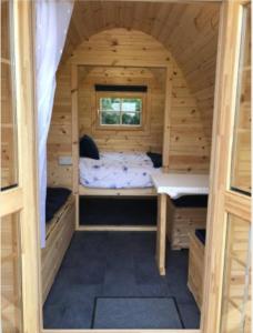 a small cabin with a bed and a window at Pen y Buarth Pod - Caravan Site in Caernarfon