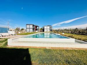 a swimming pool in the yard of a house at Cubos de Chacras AZUL in Mendoza
