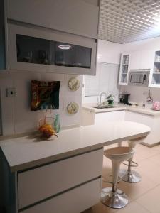 a kitchen with white counters and a white counter top at Country Block-Holiday home in Kgaphamadi