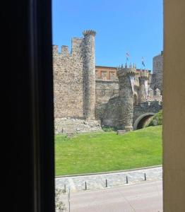 a view of a castle from a window at El mirador templario in Ponferrada