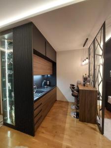 a kitchen with a counter and a table in a room at TORRO LUX Apartment in Palić