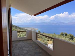 a balcony with a view of the water at Tranquility Mountain & Sea View Koudoura House in Trápeza