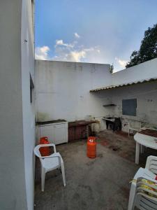 a patio with two white chairs and a table at Enjoy the Island - Rua do Negrão in Ponta Delgada