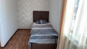 a small bedroom with a bed in a room at My Guesthome in Yerevan
