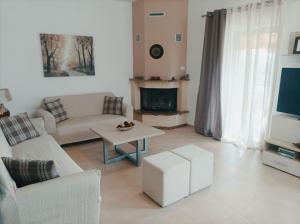 a living room with a couch and a table at Κάμπος in Rizá
