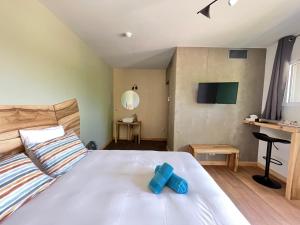 a room with a bed with a blue cross on it at Hôtel En Tilleul in Pont-du-Navoy +112 photos