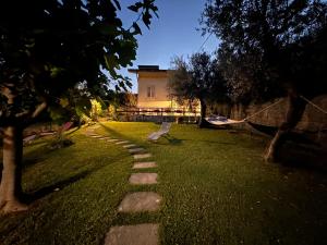 a path in the grass with a building in the background at Il Gruccione in SantʼOmero