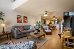 a living room with a couch and a table at Kahana Villa E409 in Kahana