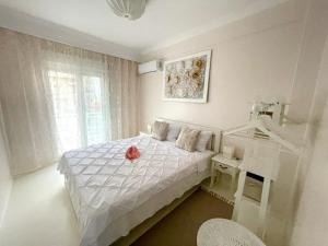 a white bedroom with a bed and a desk at White House Kavala in Kavála