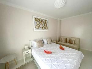 a bedroom with a white bed with red flowers on it at White House Kavala in Kavála +10 photos
