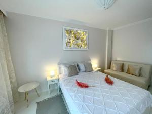 a bedroom with a bed with red pillows on it at White House Kavala in Kavála
