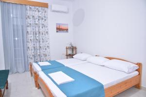 Postel nebo postele na pokoji v ubytování ZeusPlace Konaki House Leptokarya