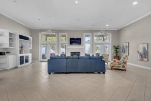 a large living room with a blue couch in a room at Waterfrnt, Swim-Fish, Near I10-Bchs Sunset Getaway in Milton