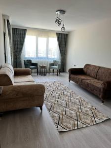 a living room with two couches and a rug at Moonlight Suite Hotel in Trabzon