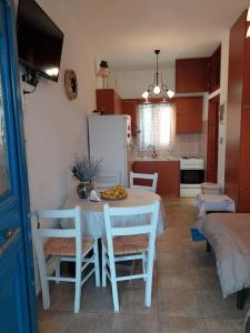 a kitchen with a table and chairs in a room at Peaceful and quiet apartment. in Aliki