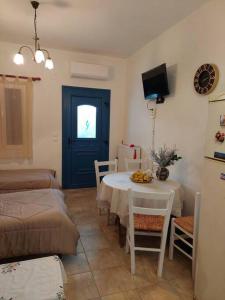 a living room with a table and a couch at Peaceful and quiet apartment. in Aliki