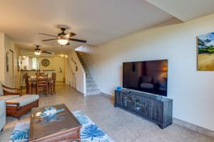 a living room with a large flat screen tv at Kahana Villa E111 in Kahana