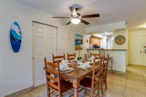 a dining room and kitchen with a table and chairs at Kahana Villa E111 in Kahana +22 photos