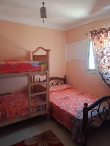 A bed or beds in a room at Free Wi-Fi شقة فندقية فى الاسكندرية New apartment sea view Alexandria
