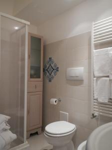 
a bathroom with a toilet, sink, and shower stall at Casa Bouganville in Positano
