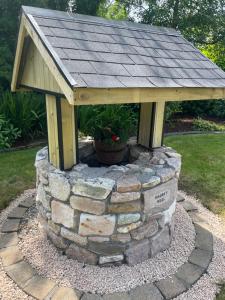 a bird house sitting on top of a stone wall at Cosy Rooms in a Stone Cottage in Galway