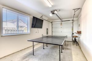 a ping pong table in a room with a tv at Riveredge Retreat in Seaside
