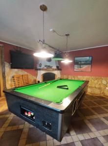 a living room with a pool table in a room at Chata Gatterhof in Banská Štiavnica