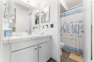 a white bathroom with a sink and a toilet at Kihei Akahi B102 in Wailea +12 photos