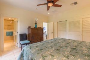 a bedroom with a bed and a ceiling fan at Kapalua Golf Villa 27V 3 in Kahana +31 photos