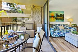 a living room with a table and a couch at Paki Maui 319 in Honokowai