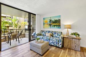a living room with a couch and a table at Paki Maui 319 in Honokowai