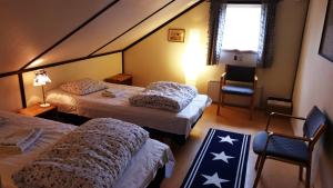 a hotel room with two beds and a window at Twister 53 in Sparreholm