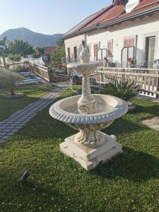 a fountain in the grass in front of a house at Astra in Agerola