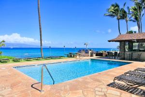a swimming pool with the ocean in the background at Noelani 104 in Kahana +21 photos