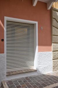 a building with a window with blinds on it at CAMERANOAPARTMENTS - L'ANGOLO DELLA PIAZZA in Camerano